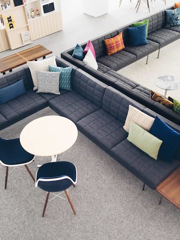 Overhead view of a lounge area anchored by two back-to-back gray Tuxedo sectionals.