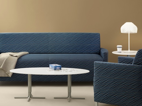 A blue Pamona Flop Sofa and complementary chair in a healthcare lounge.