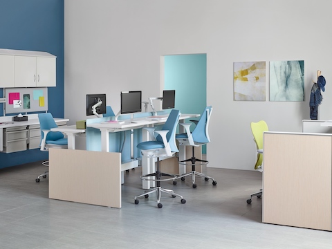 Co/Struc modular storage components, light blue Sayl Stools and a green Mirra 2 office chair in a healthcare setting. 
